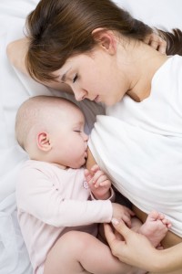 close-up portrait of mother breast feeding her baby infant